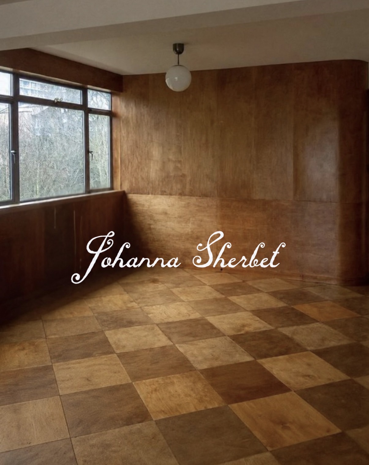 Johanna Sherbet, a sunlit room with wood-panelled walls and a tiled floor.